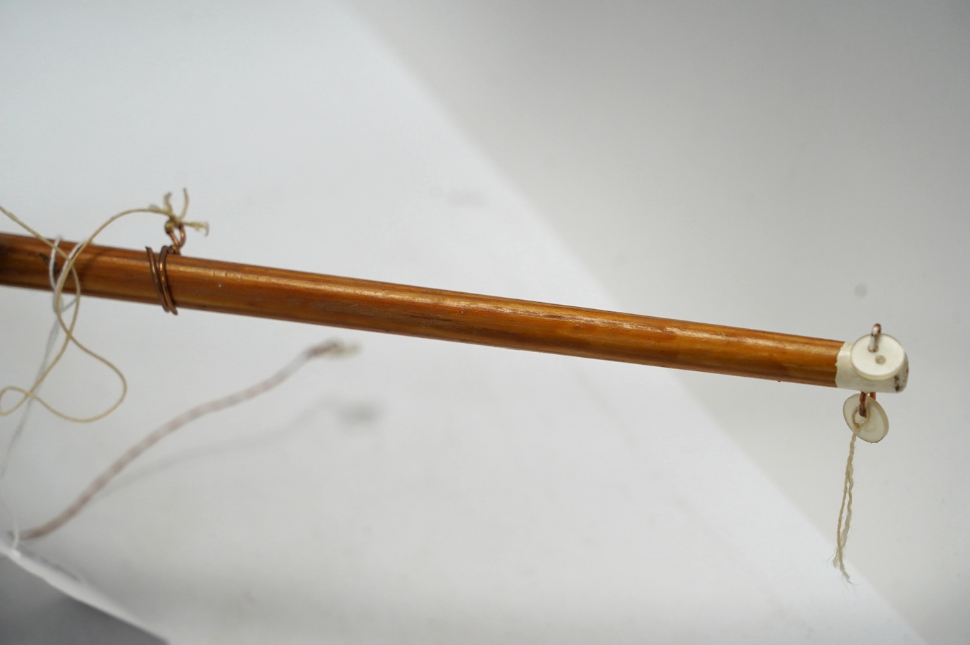 A painted wood pond yacht, 77cm in length. Condition - one mast broken